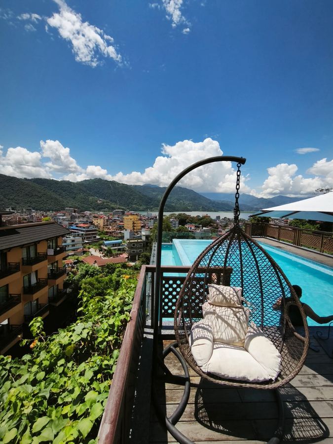 A hanging chair on the pool deck