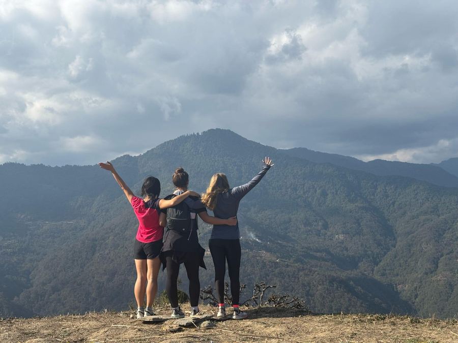 Three guests celebrating on a hilltop